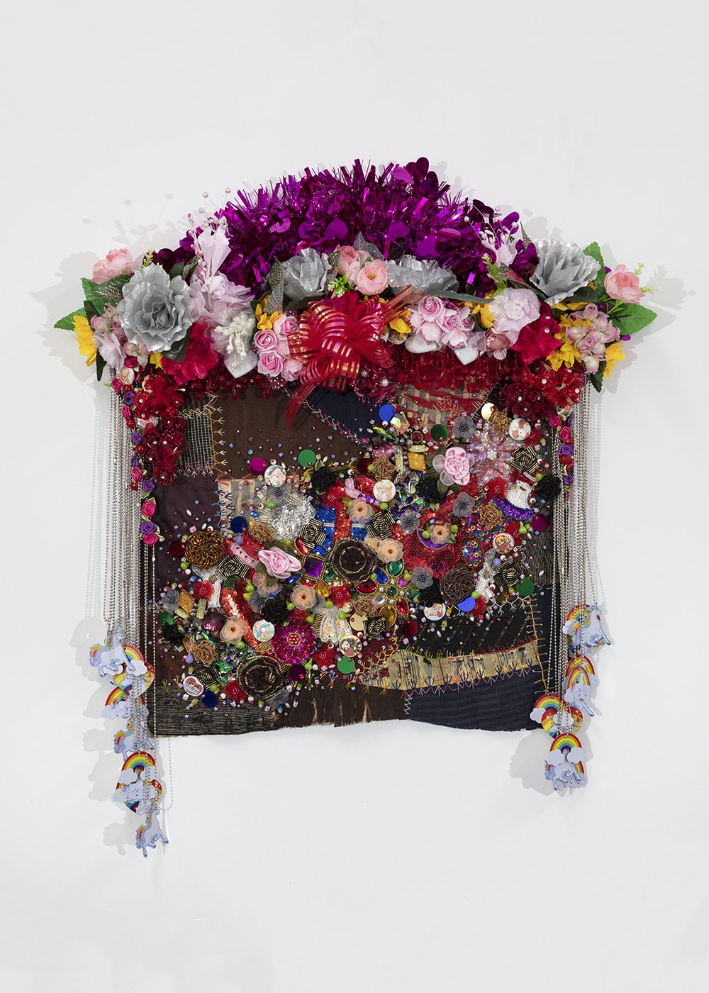   Shroud #5 (study) , 2022, Found ‘Crazy’ quilt ca. 1900, trim, fabric flowers, garland, costume jewelry, buttons, plastic flowers, beads, sequins, thread, fabric, pine, 31 x 26 x 5” 