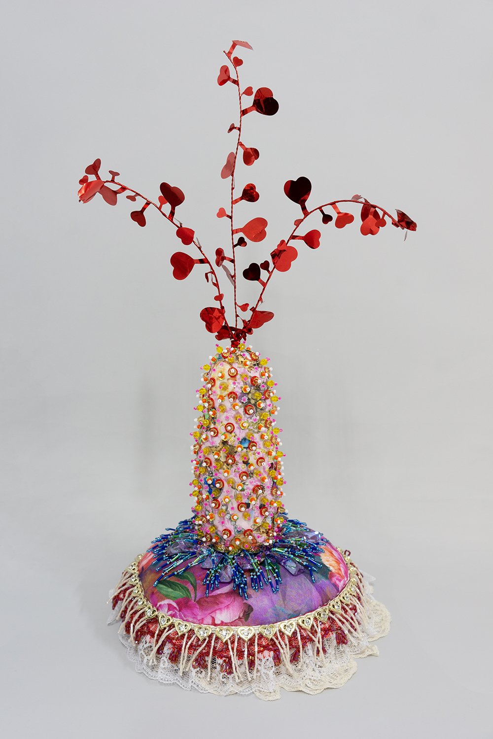   Untitled,  2024, Plastic and crystal beads, found fabric, trim, charms, tinsel, wire, polyester batting, thread, 20.5 x 11 x 10” 