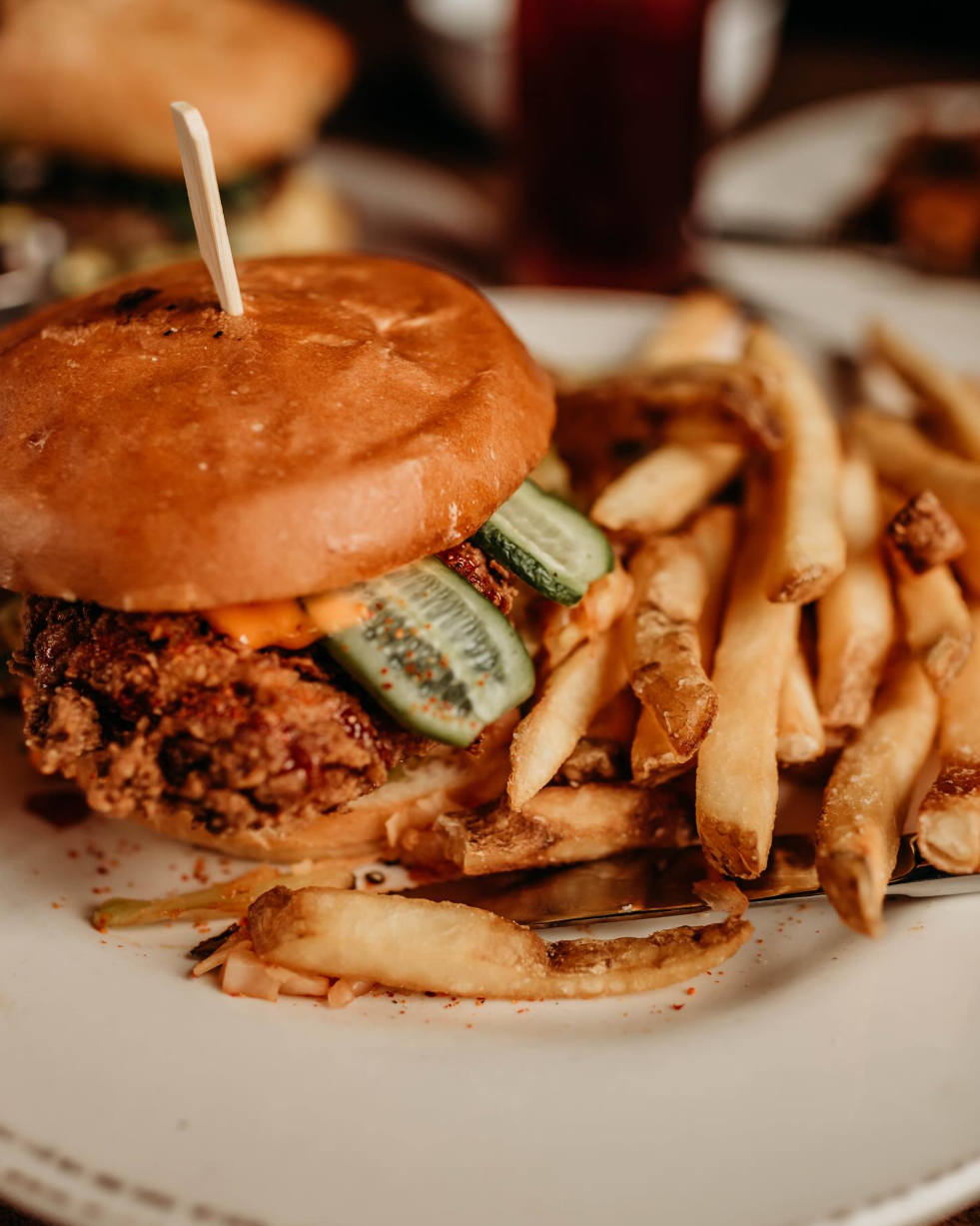 A restaurant made crispy chicken sandwich with fries