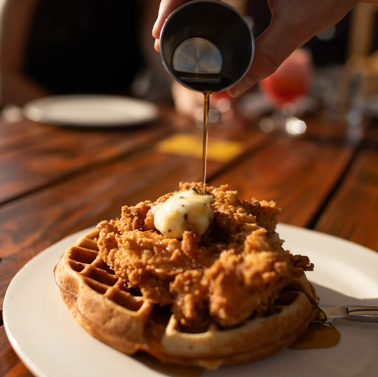 Restaurant made chicken and waffles with drizzled syrup
