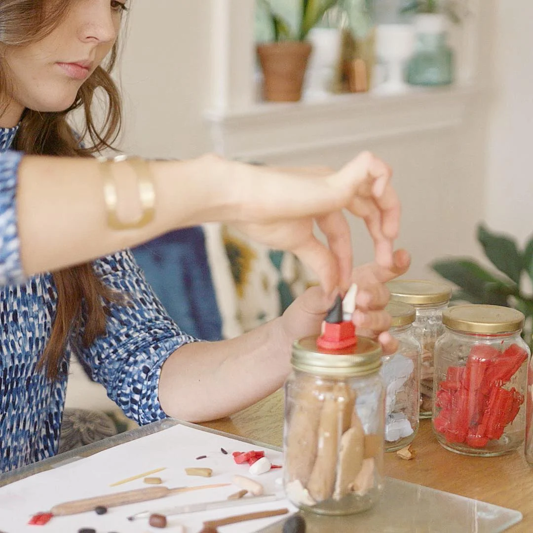 Laura, owner of Little Clay Land, creating custom clay portraits.