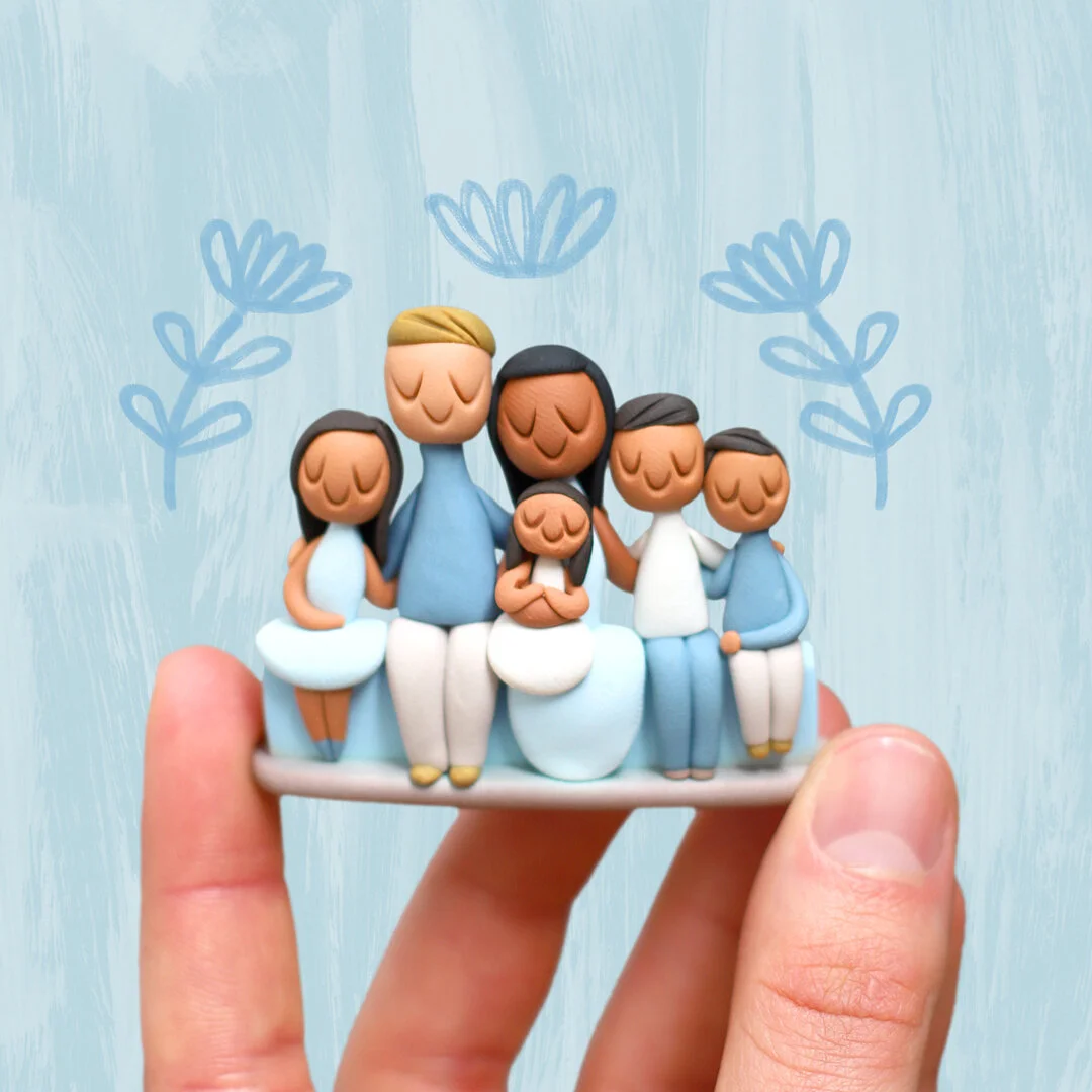 Custom handmade ornament: clay family with baby.