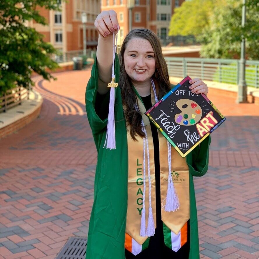 student holding her grad cap 