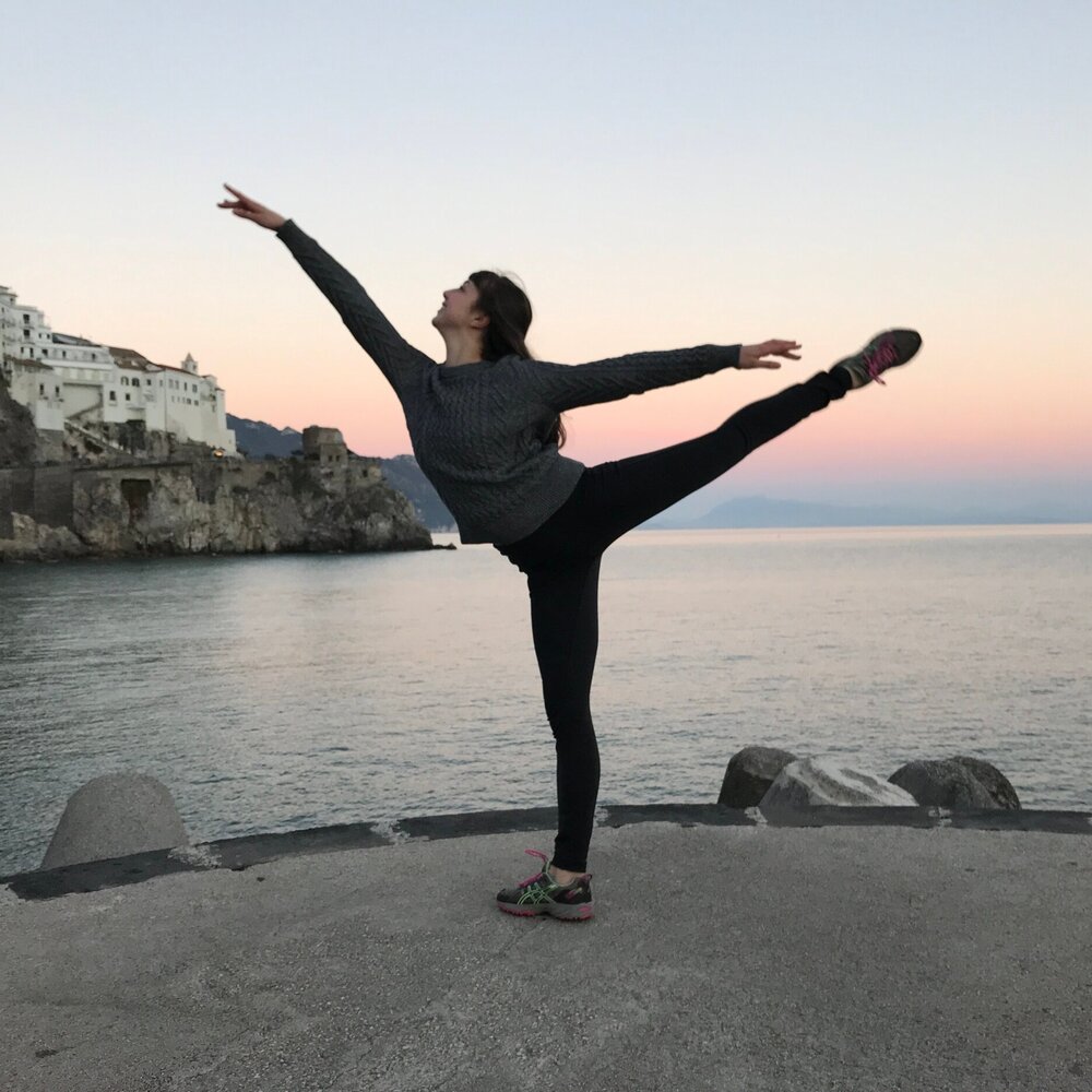 dancer in arabesque with beach in background 