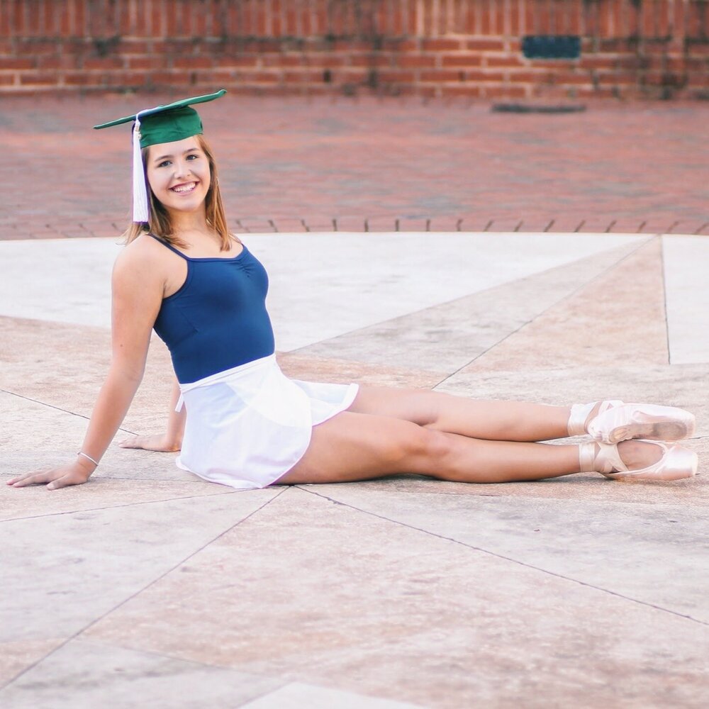 dancer in point shoes and graduation cap