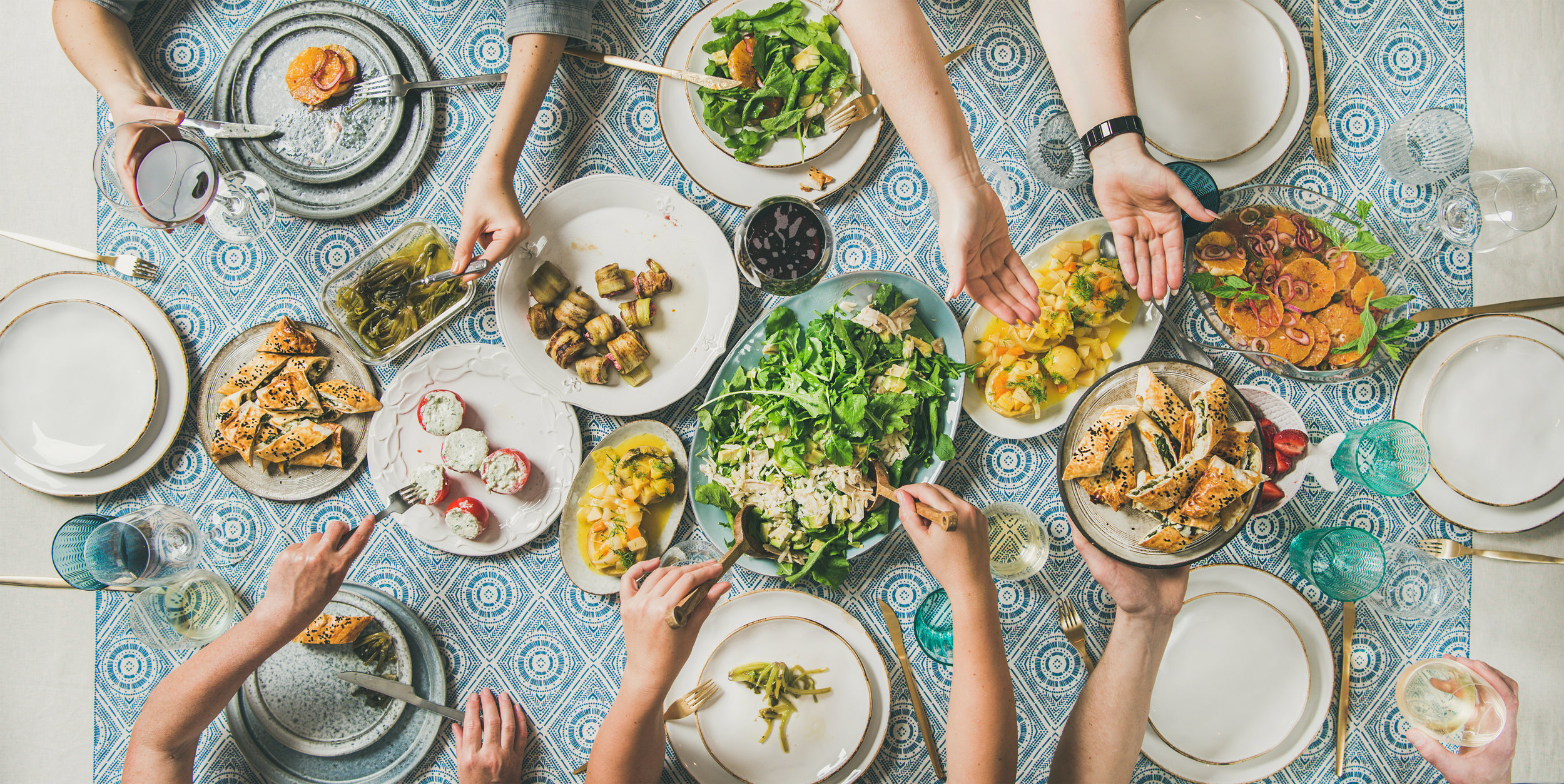 People sharing food on table