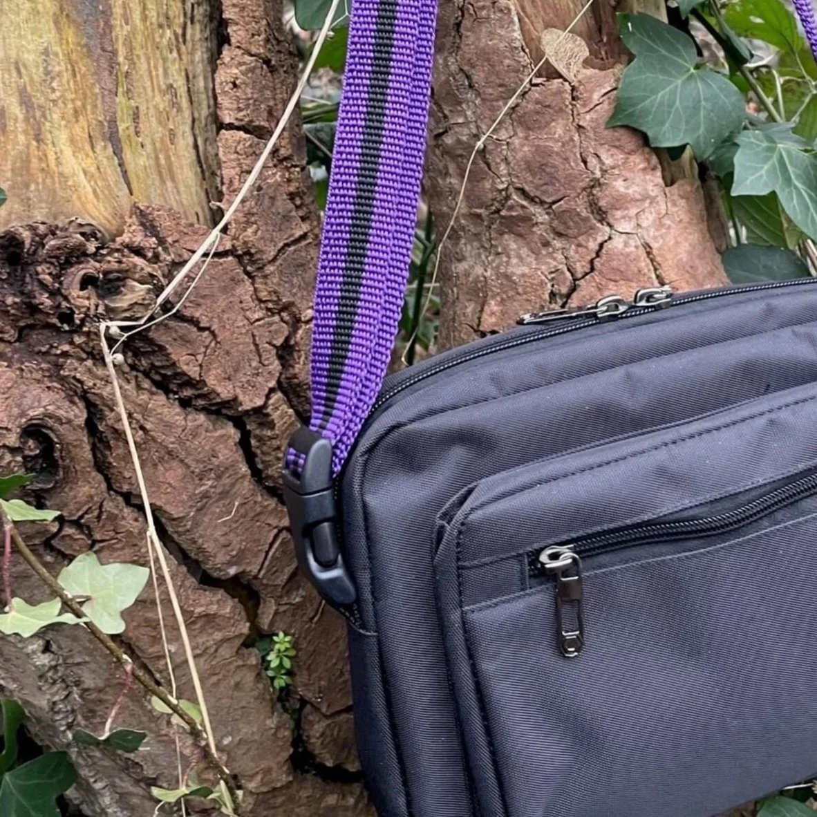 black close up image of Reg&Bob dog walking bag with purple strap