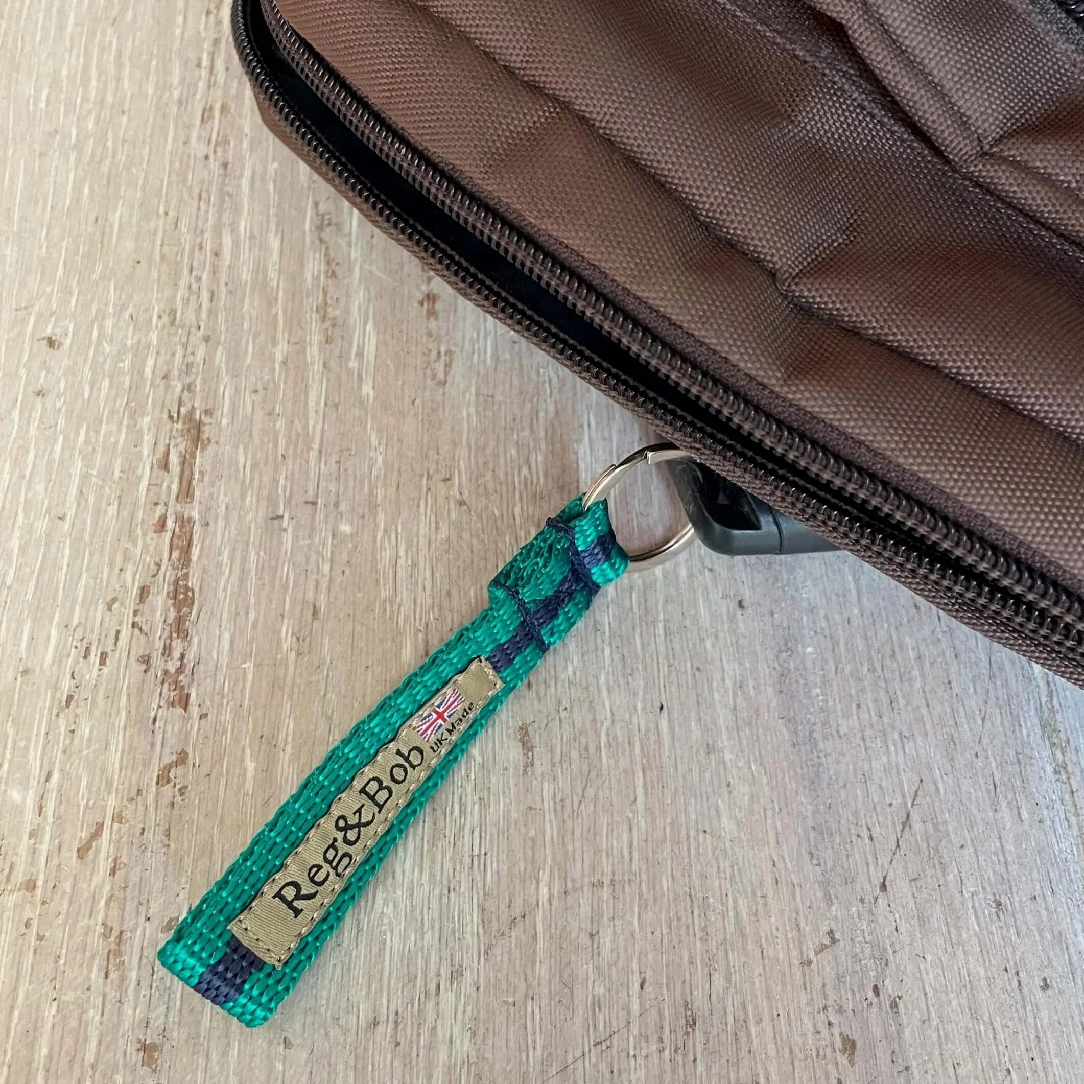 jade striped keyring by Reg&Bob with a partly shown Reg&Bob brown dog walking bag