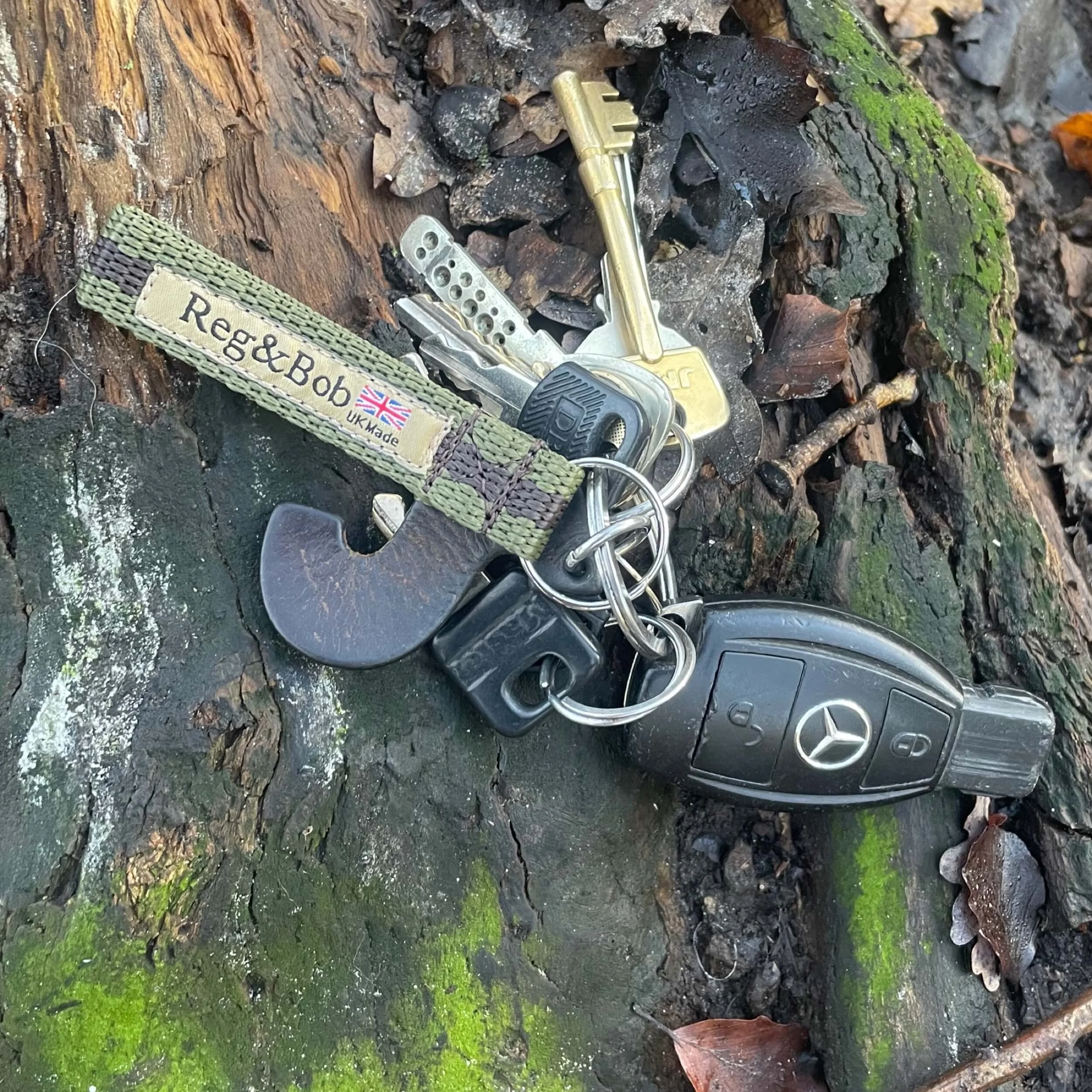 khaki keyring by Reg&Bob sitting on woodland floor