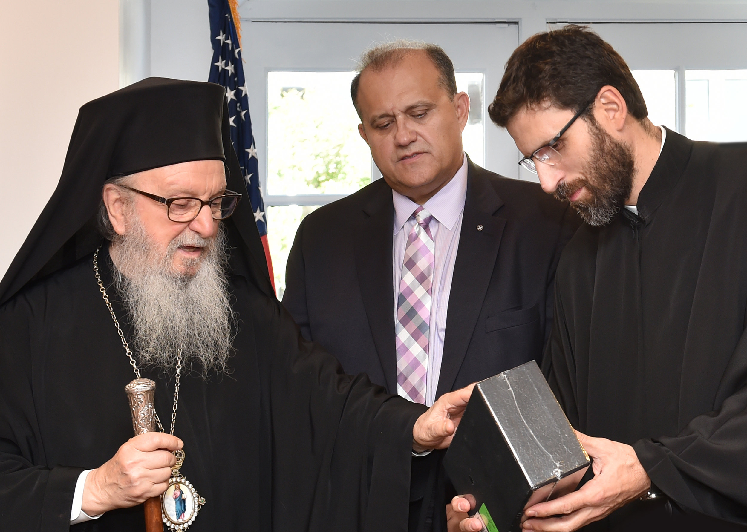  His Eminence presents to Mr. Larigakis a gift of books written by His Eminence and the Ecumenical Patriarchate for the new library. 