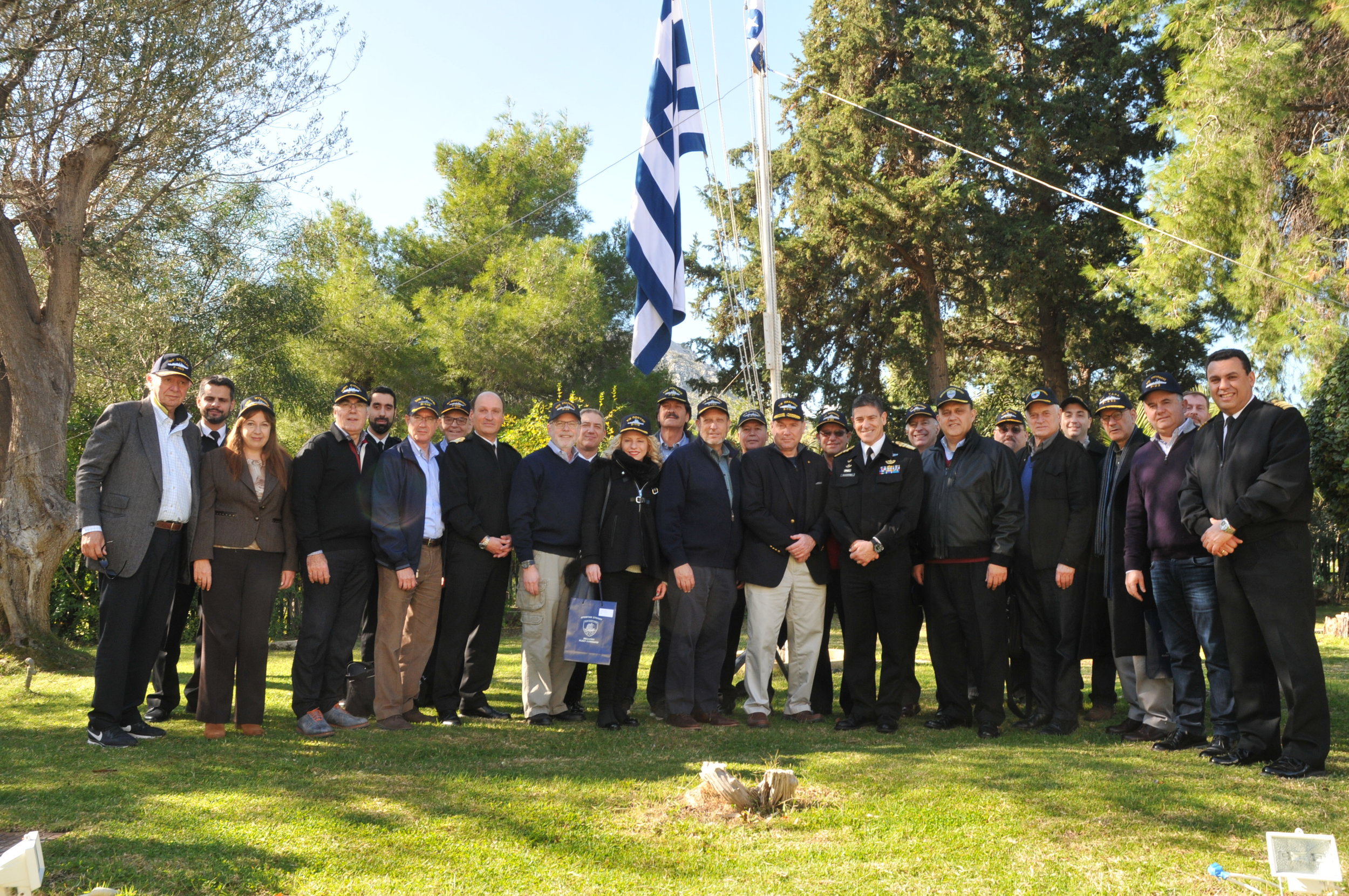  Delegation poses with naval caps provided by Vice Admiral Pavlopoulos outside his residence at Salamis Naval Base.&nbsp; 