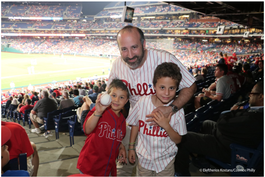  Father enjoying Greek Heritage Night with his sons (courtesy of cosmosphilly.com)   