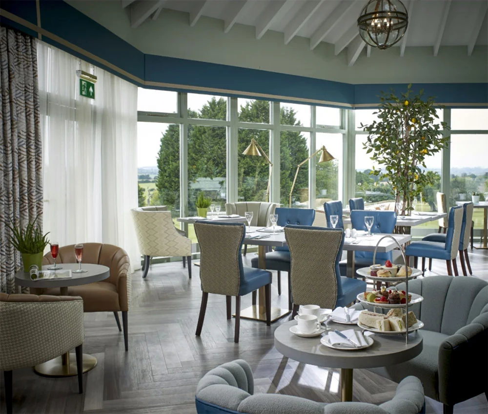 Restaurant // Decorated in crisp blues and creamy browns in the Walter and Opera armchairs with huge windows taking in those dreamy views. Photo © Tewkesbury Park Hotel, UK