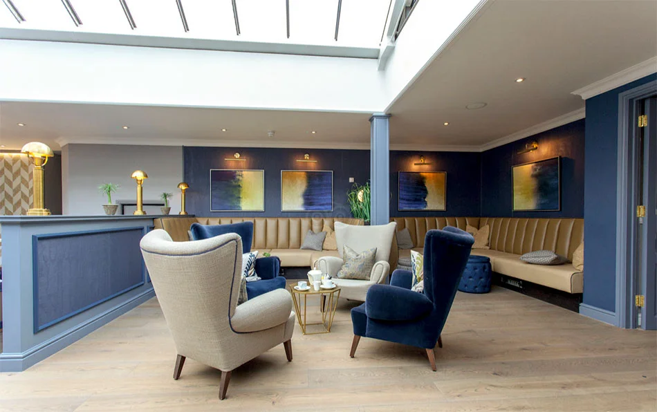 Lobby // The interiors are casual-smart with Tommy armchair by Larforma and there’s a generous sense of light and space in the public areas, which are decorated in crisp blues and mellow yellows. Photo © Tewkesbury Park Hotel, UK