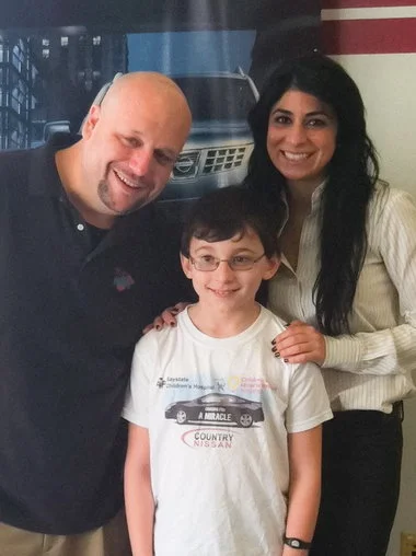 From left, Chris Kellogg, of 94.7 WMAS, Matthew Dion, of Springfield, a Childrenâs Miracle Network âMiracle Kid,â and Carla Cosenzi, president of Country Nissan, during the Hadley dealershipâs kickoff event on Feb. 11 to mark National Cancer Prevention Month.