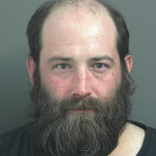 Battery suspect accused of spitting on officer