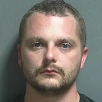 Sitting in I-69 median led to arrest