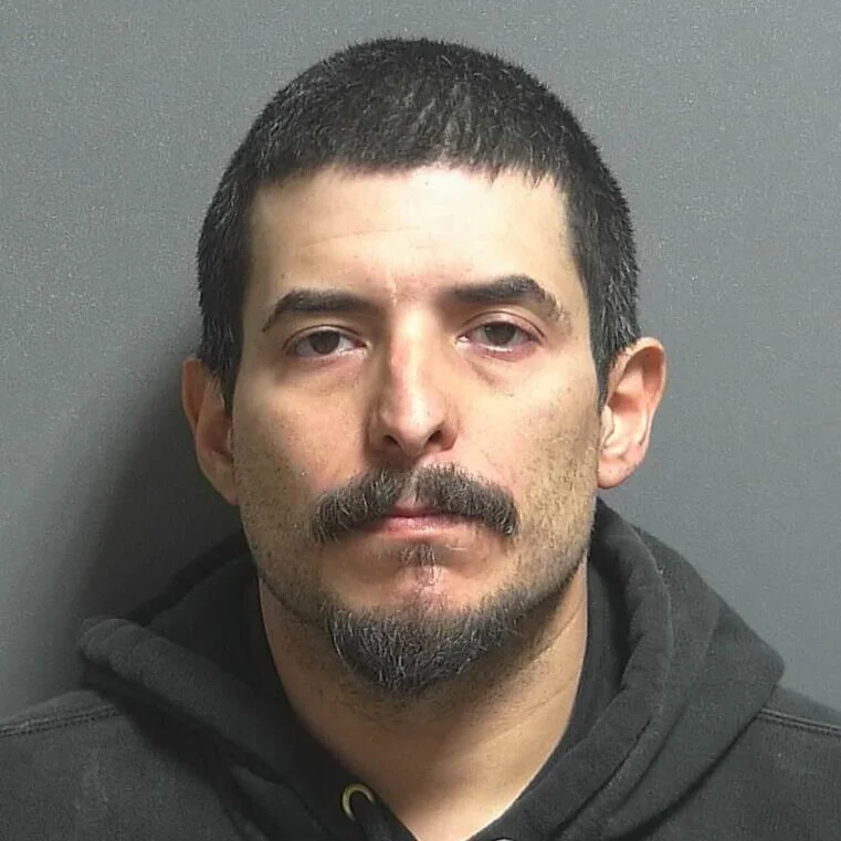 Suspect in shooting last May is accused of threatening to shoot another person 