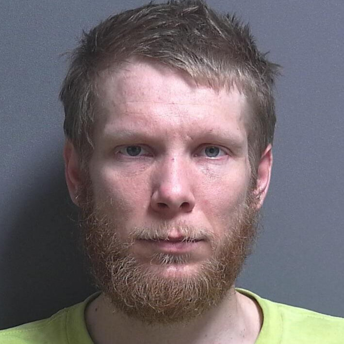 Man accused of intimidation, battery and spitting on a woman