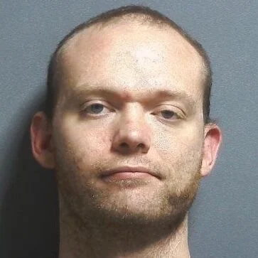 Charges filed against suspicious man found with a loaded handgun on school property