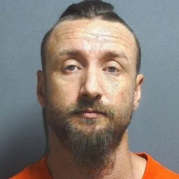 Wanted man found sitting with meth and syringe close by