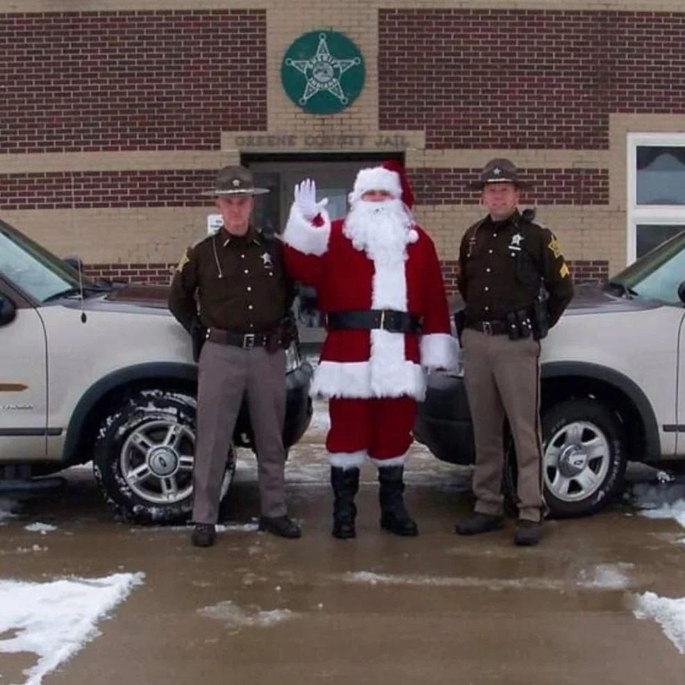 Sometimes Santa Claus comes in a patrol car, assisted by GCSD Reserve Officers