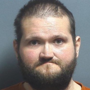 Man walking around a parking lot asking people for money arrested