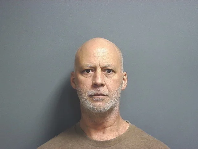 Man held without bond after threats to state official