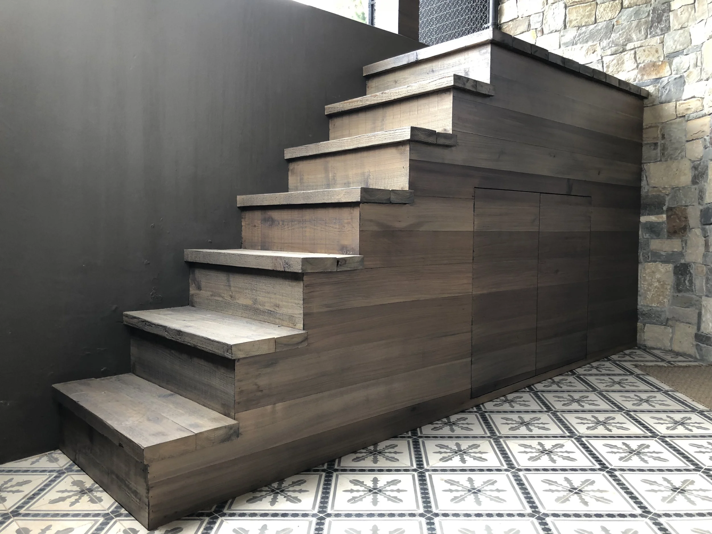  Cedar staircase to access pool equipment also hides a meter below. 