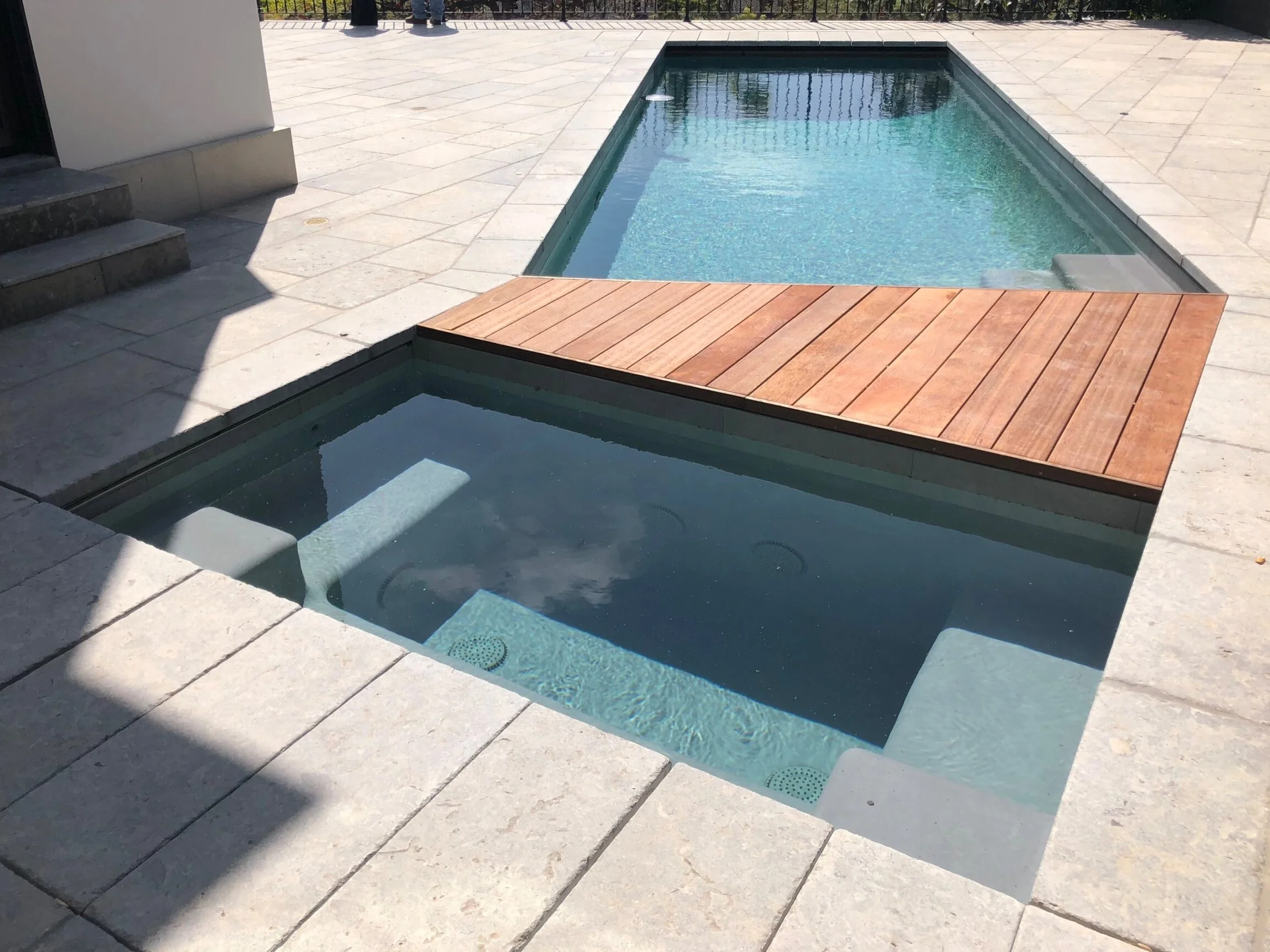  Both pool and hot tub have automatic covers hidden underneath the coping. 