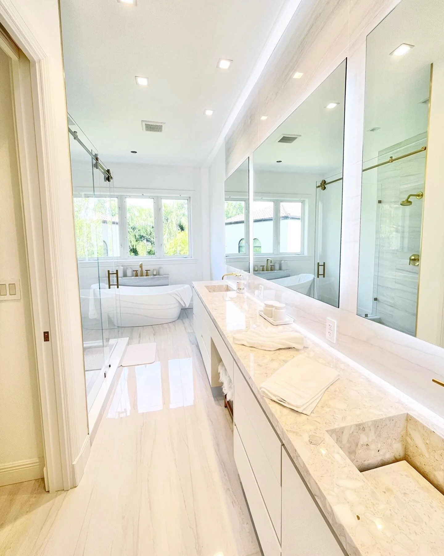Complete re-work of this Master Bathroom layout made for an endless double vanity with enough space for a makeup cove. #Swipe to see the before. My favorite details have to be the integrated sinks and mirror trio. Firm believer of always doing things