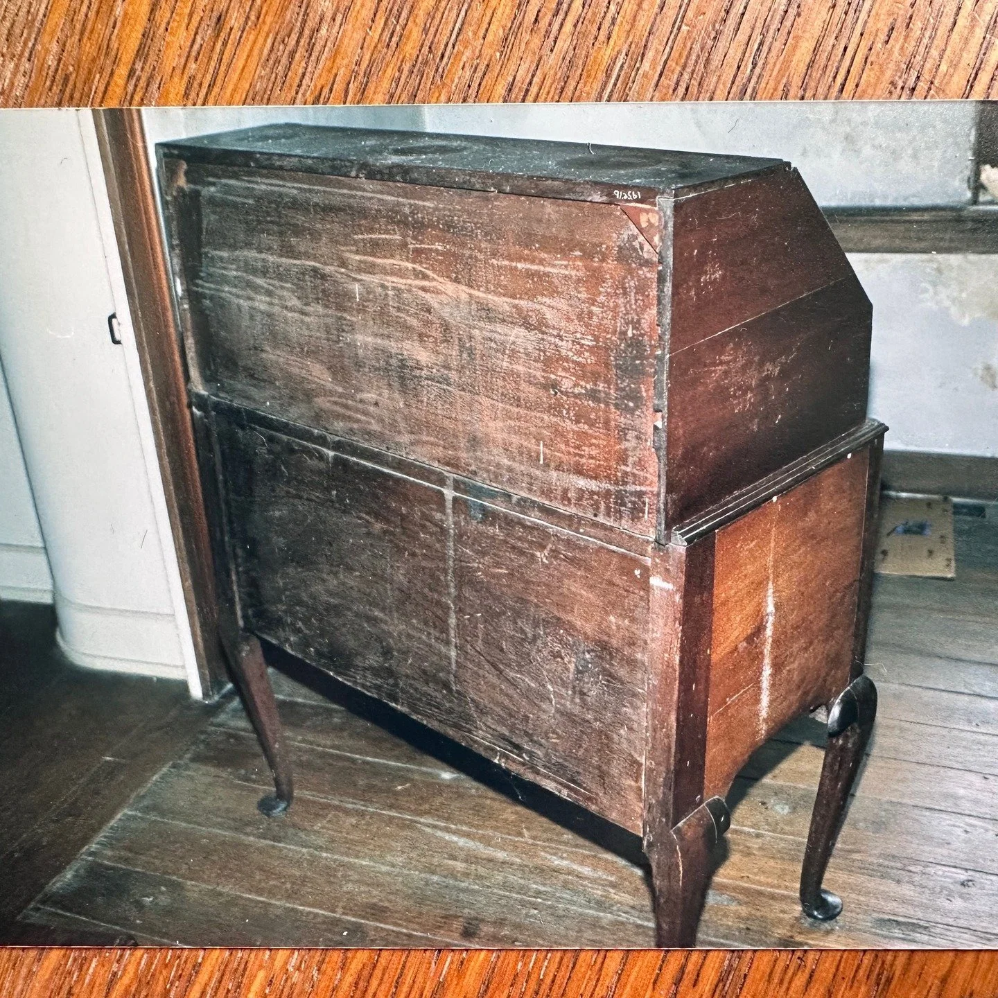 Insect infestation. Identified as an 'old house borer' the beetle came up through the floor into the leg of the desk. The exit holes are visible below the waist moulding and the mound of frass on the floor is impressive. #hellerconservationservices #