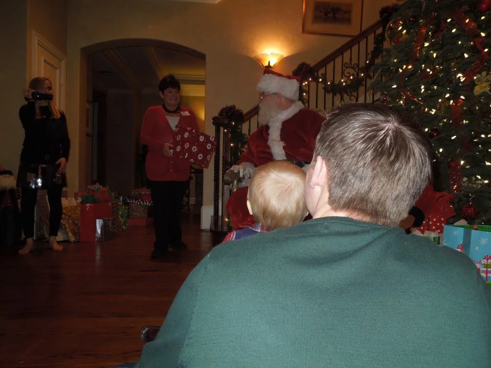 Mom bringing Santa a present for one of the cousins!