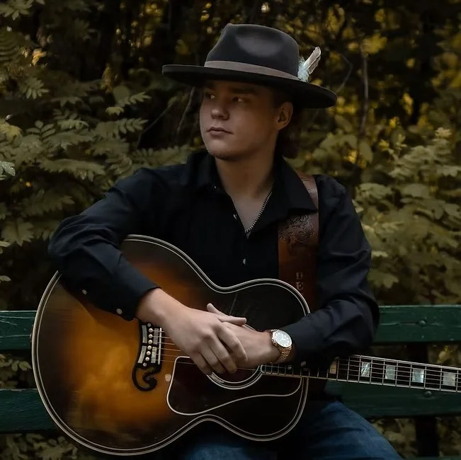 Photo of Jaden decker holding a guitar
