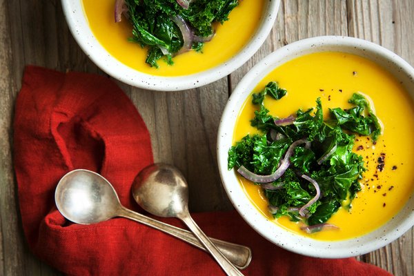 We don't know about you, but serving up some feel-good food seems like a nice idea right about now. Let this soup's mellow flavors of squash, kale and red onion fill you up. Photo by Peter DaSilva from The New York Times