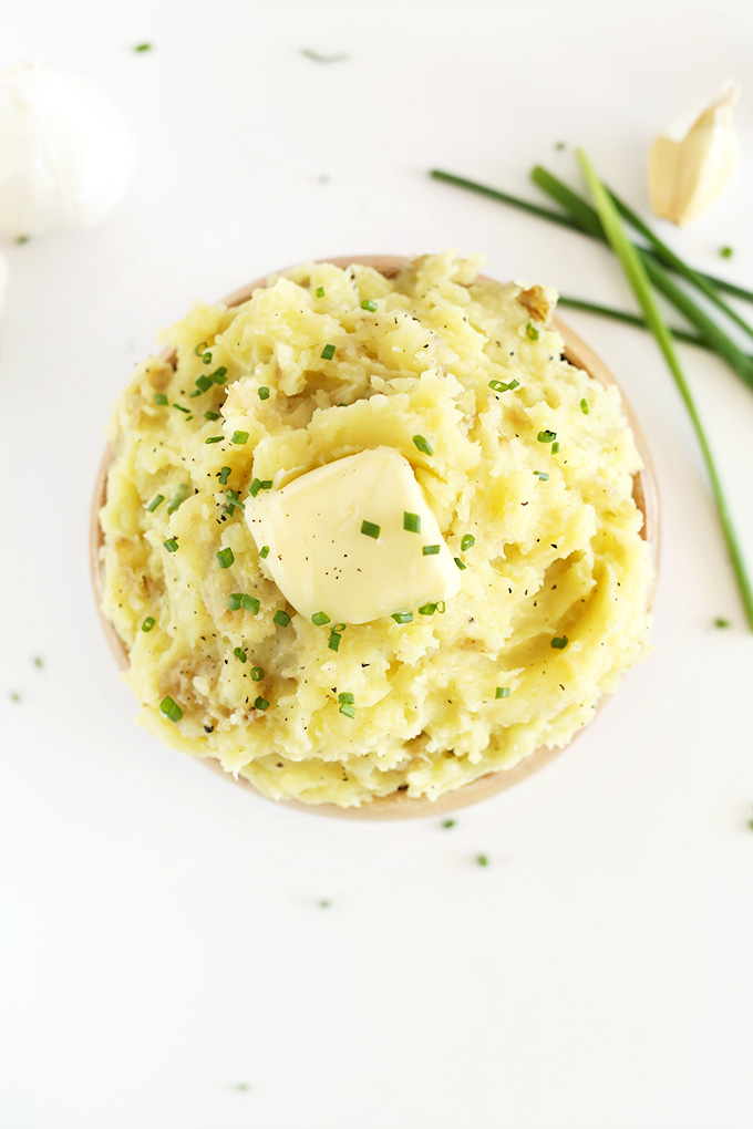 Try this vegan specific six-ingredient mash - it's creamy, buttery, fluffy and perfectly spiced with roasted garlic and chives. Photo from Minimalist Baker .