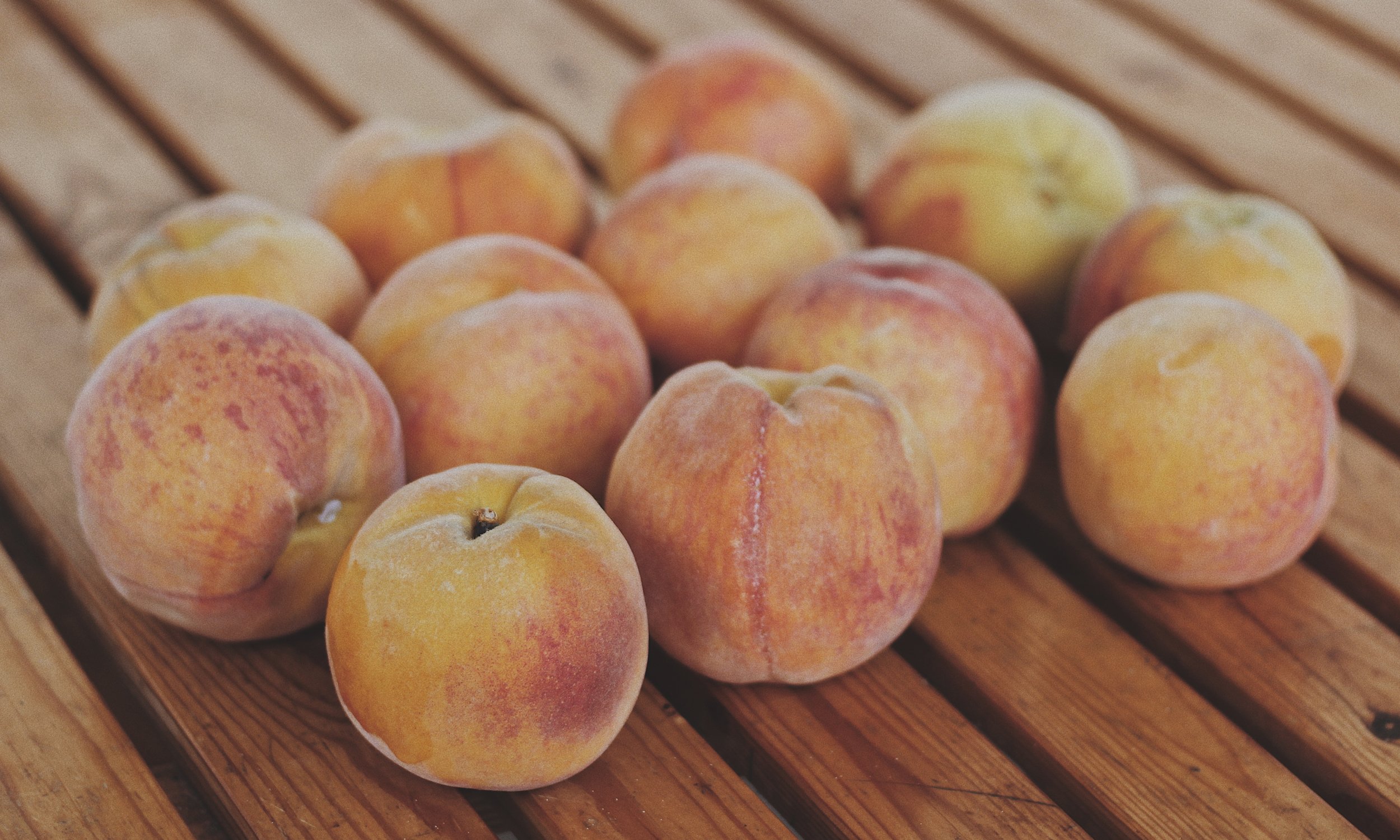 Baked peaches are delicious with ice cream or yogurt, especially when garnished with a crunchy, nutty crumble and a dash of rosemary.