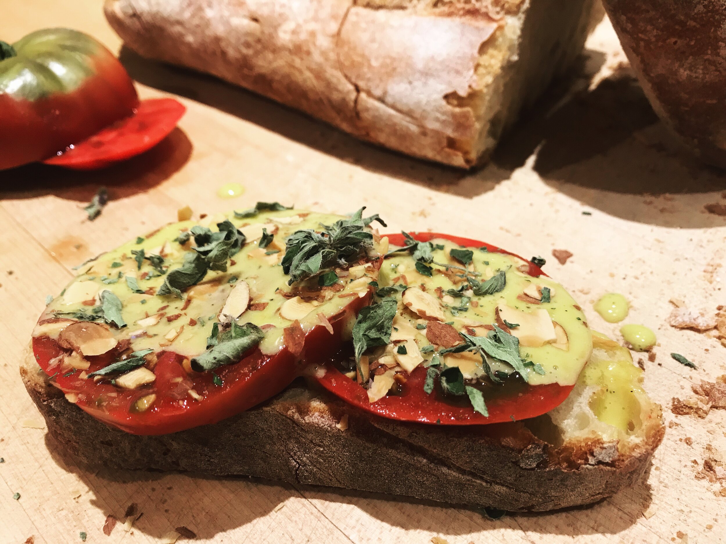 This recipe may seem simple — and it is. But, in the fleeting moments of summer, tomatoes are meant to be eaten raw, and often. This spin on a classic tomato sandwich uses a light miso aioli to highlight the savory, umami quality of tomatoes while contrasting their perfect, acidic sweetness.