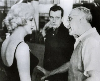 Arguing with George Cukor, famous comedy director, on the set of Let’s Make Love (1960)