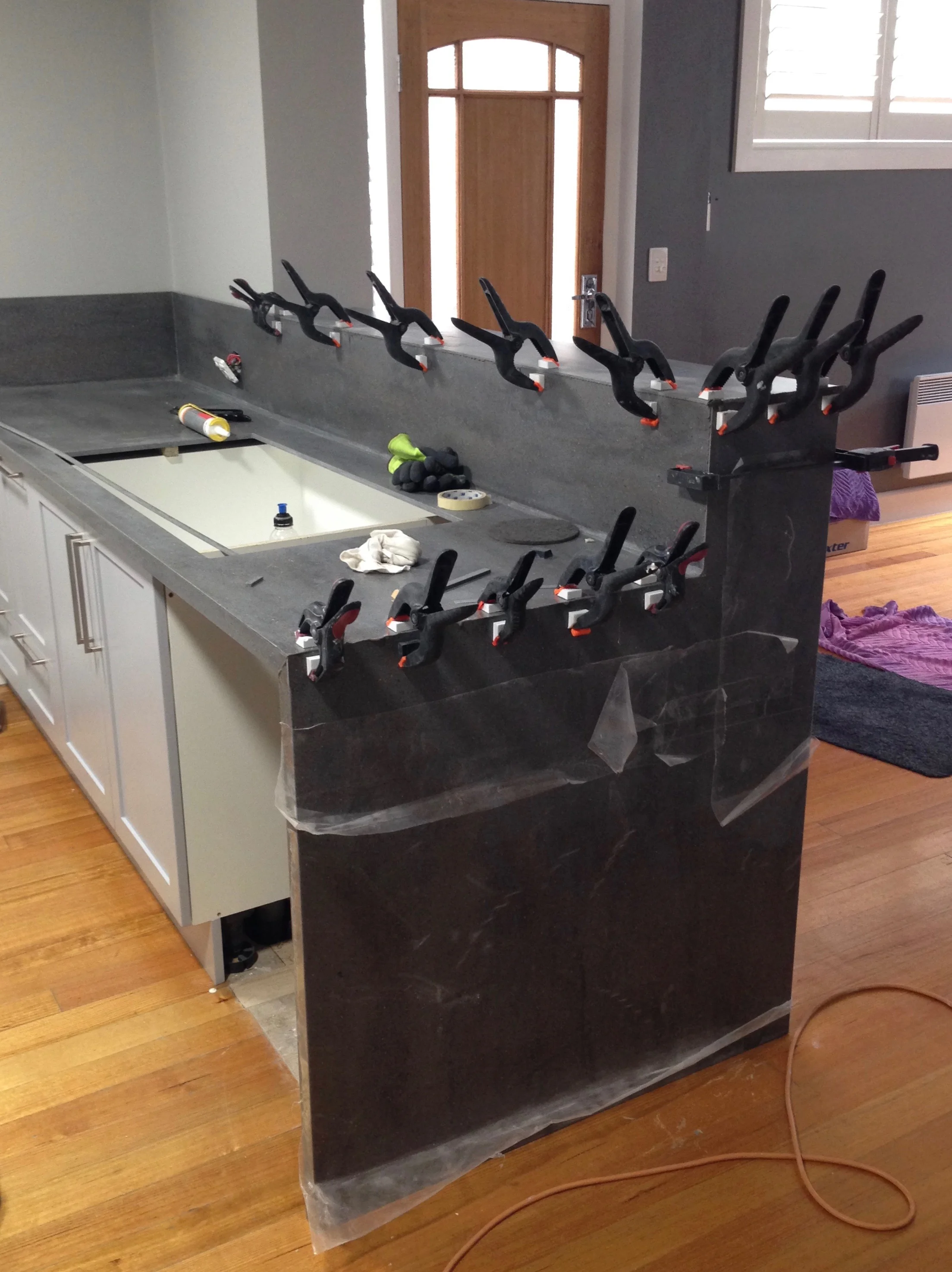 Our new kitchen bench that took 5 hours to install and two extra visits to fix badly finished joins. The material is Corian, a mineral and acrylic blend that's supposed to look seamless - well, they almost got it right!