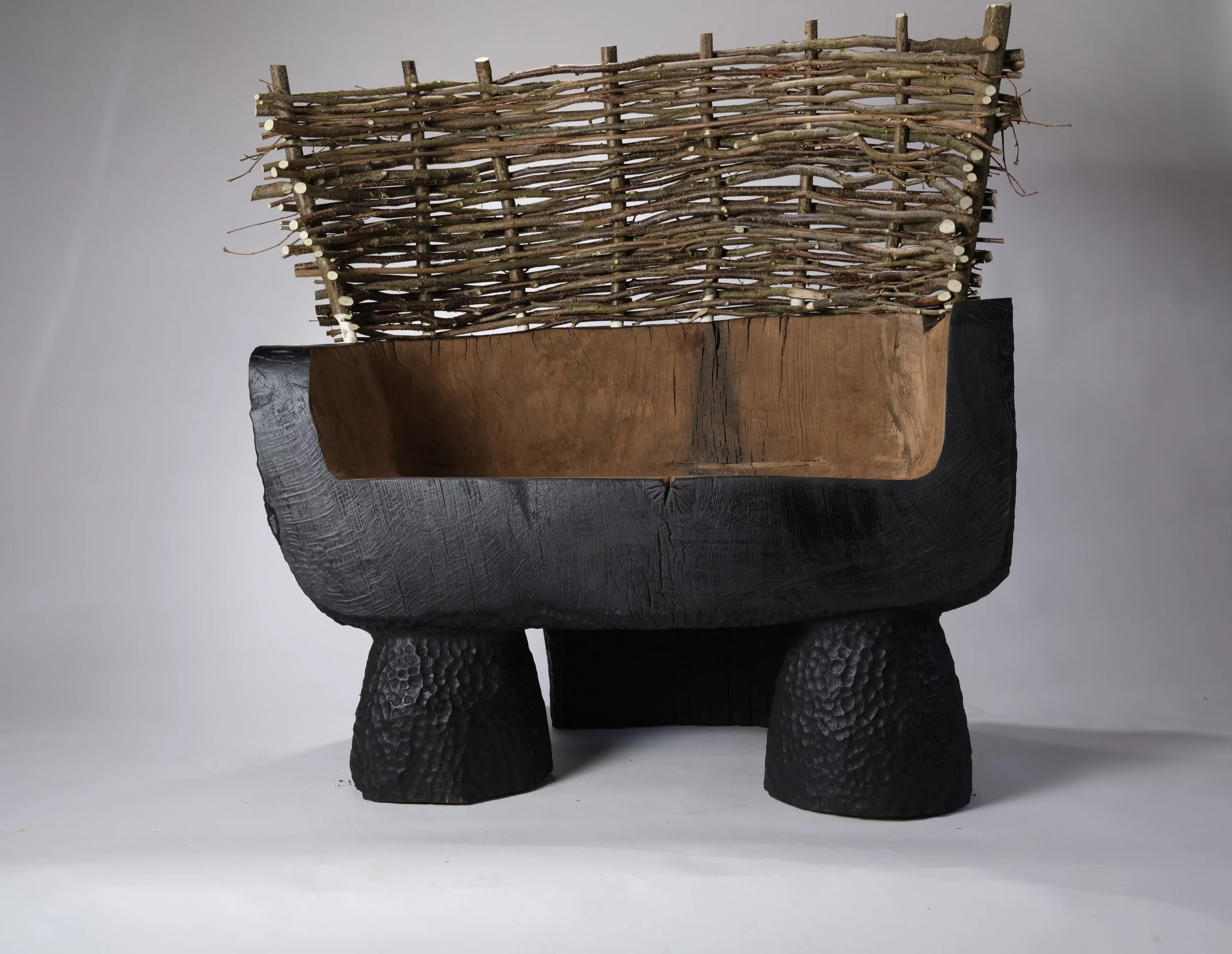 Front view of a carved Oak and Hazel seat