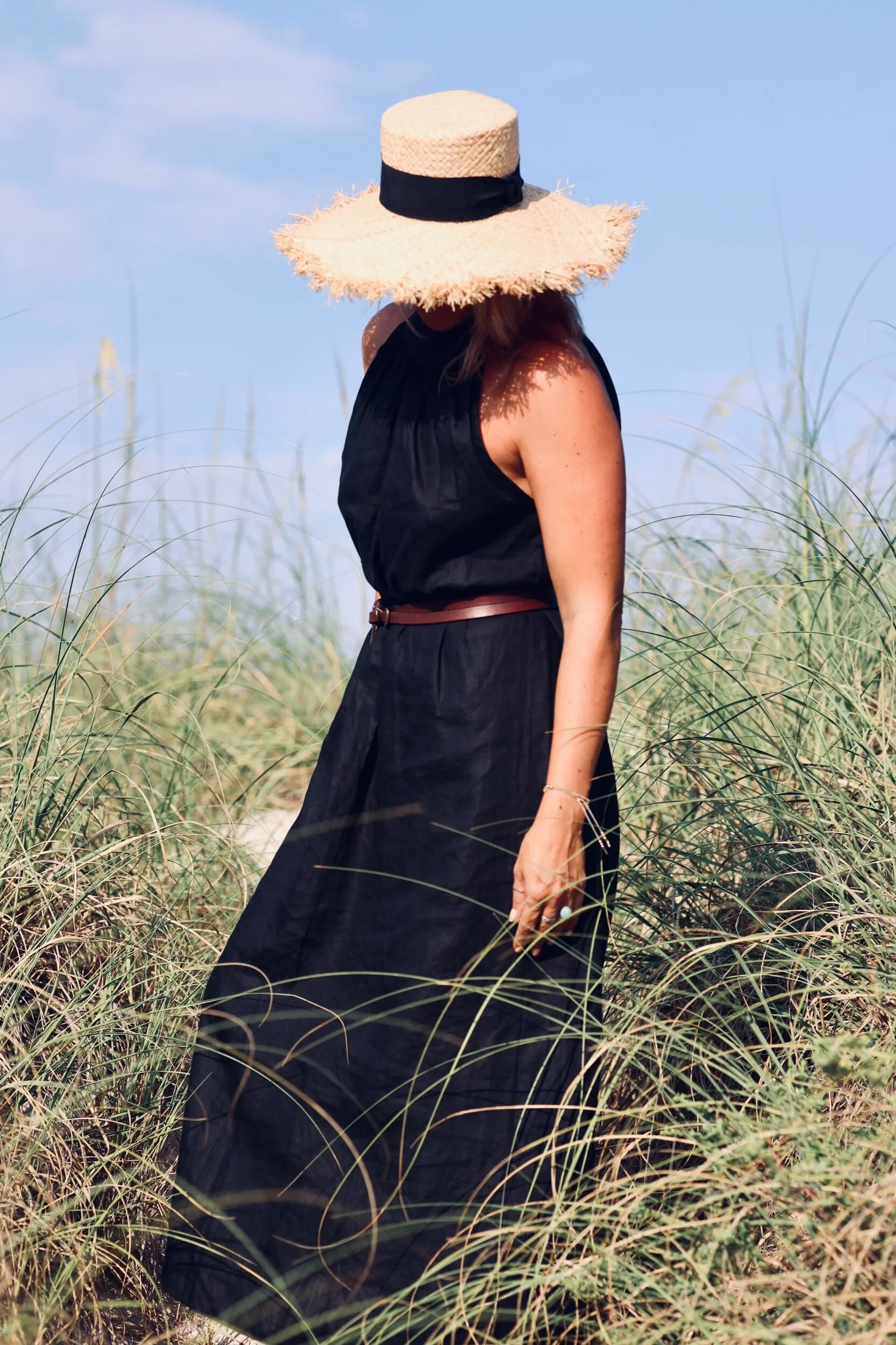 Woman wearing black linen dress.