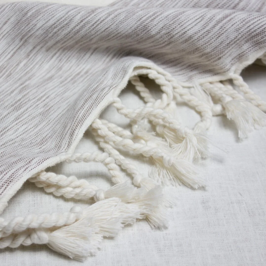 Rolled up off white bedspread.