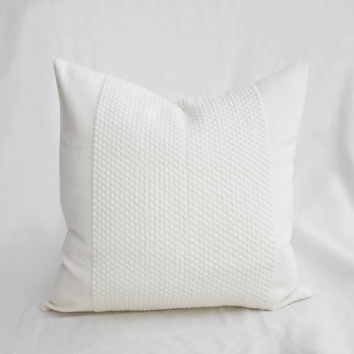 White dotted square pillow.