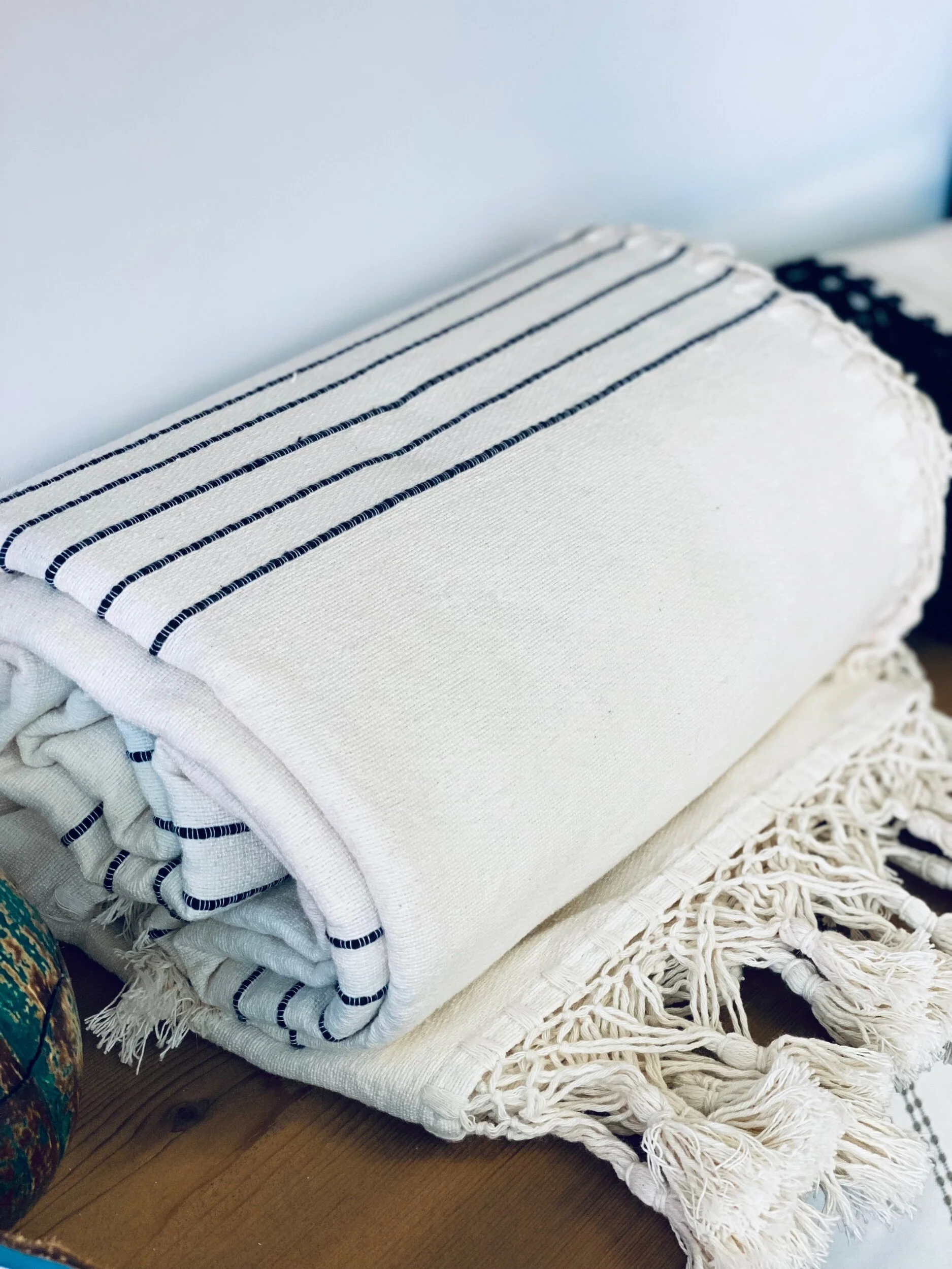 Rolled up striped bedspread.