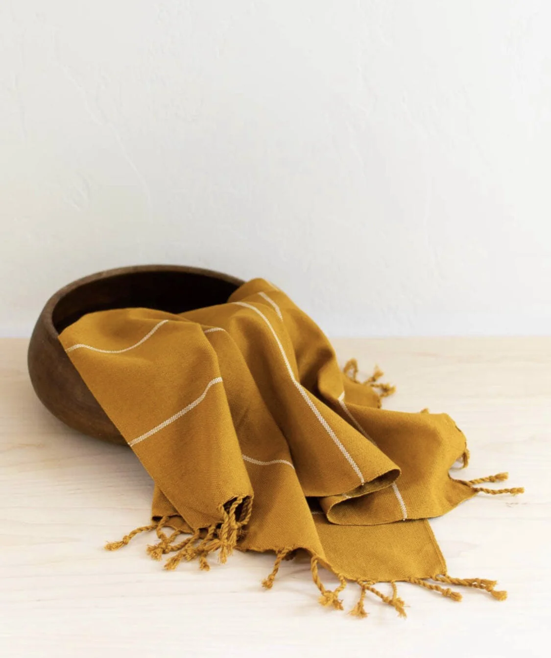 Yellow hand towel in basket.