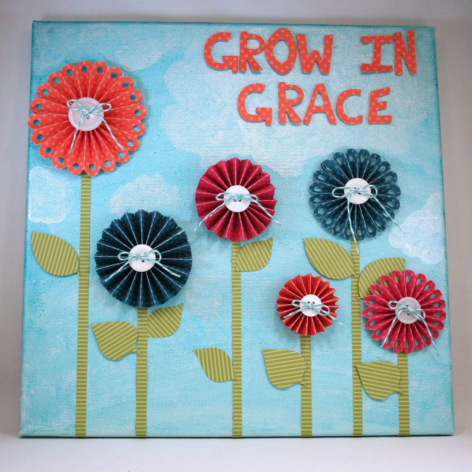 This canvas wall hanging also uses the Rosettes Die set. I love how this set has a scalloped edge rosette and a straight edge rosette. Simply cut and trim to create various sizes!