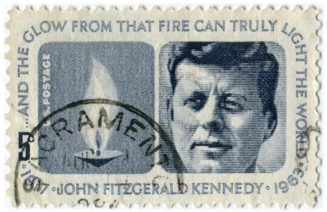 Sacrament without Truth. 'The Body of Cookie' is made up of approx 2000 cancelled 1963 JFK commemorative stamps. Found Stamp with accidental post mark "SACRAMENT' is available as an archival collectors edition in two sizes: 36 x56" ( edition of 30) and 18 x24" (edition of 350)