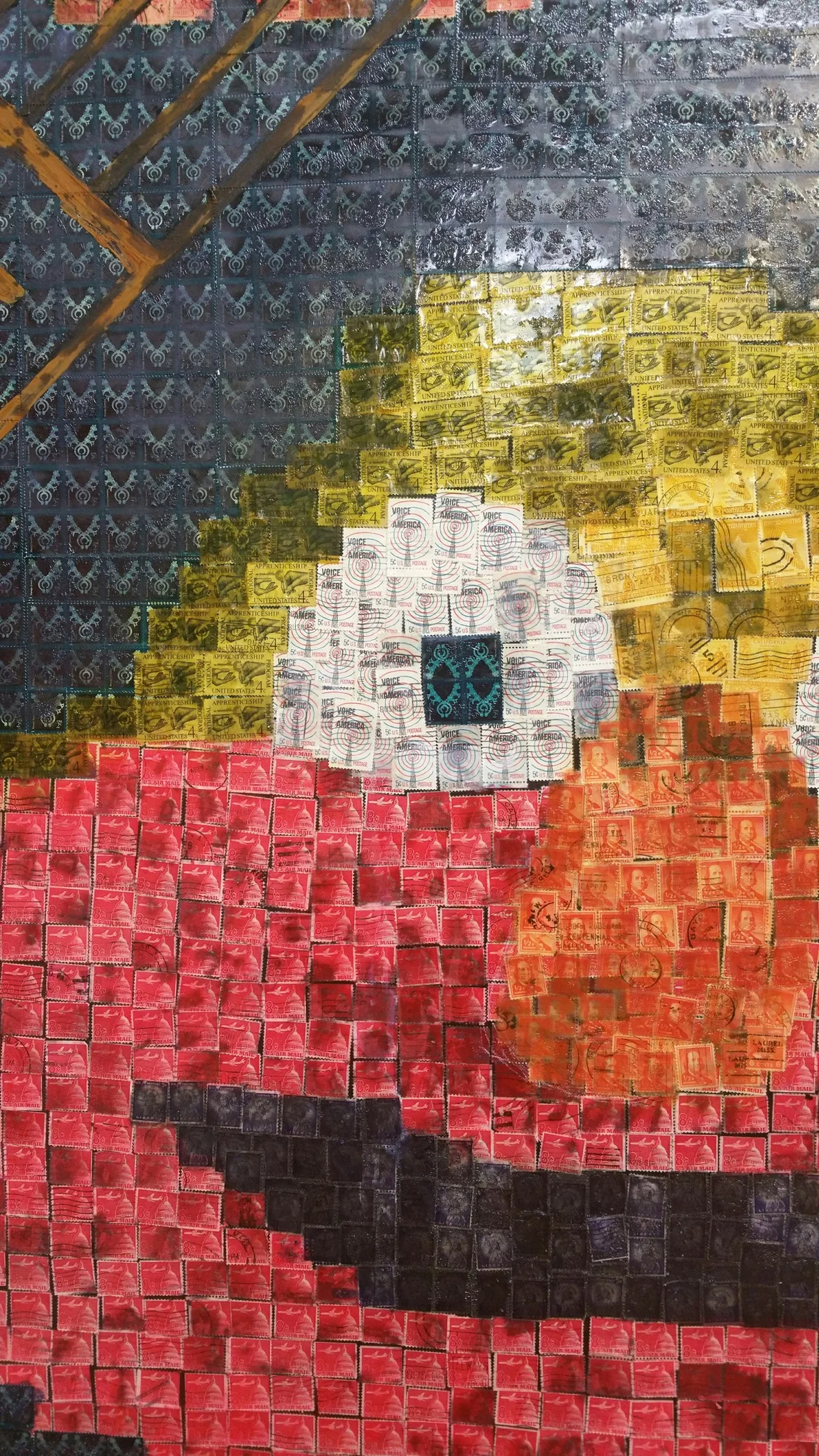 The political body is made from cancelled 1966 8¢ airmail stamps, depicting the DC Capitol and a plane. The mouth a darkened and dirty liberty, celebrating free speech and a foul mouth. The nose is Franklin, because he knows...