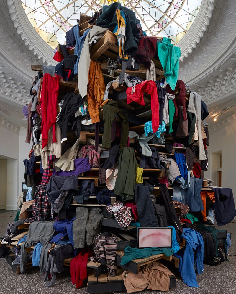 Ruth Watson, Geophagy, 2017, recycled pallets, seceond-hand clothing, monitors with 5 single-channel HD videos. Installatioin view, Gus Fisher Gallery, University of Auckland. Photo: Sam Hartnett. Courtesy the artist